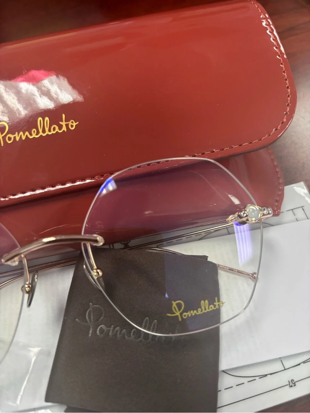 Pomellato Gold Rimless Glasses with Red Case